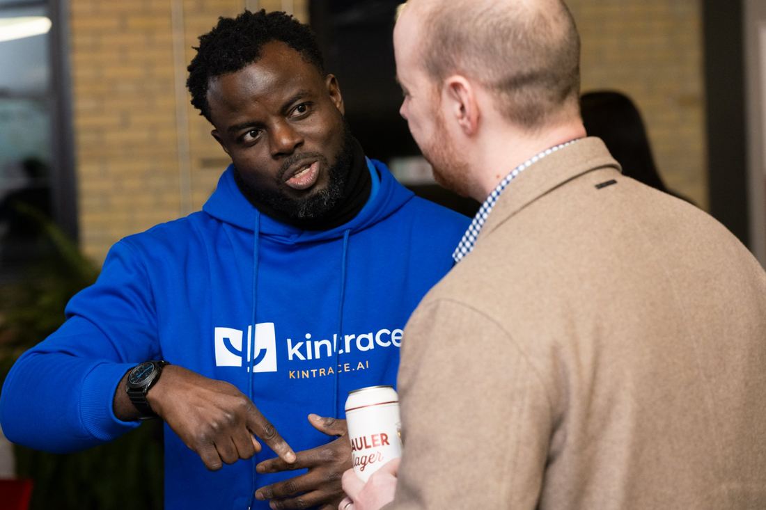 Ayoola Gbade-Bello networking during the Communitech Startup Bootcamp Demo Day, wearing a Kintrace hoodie
